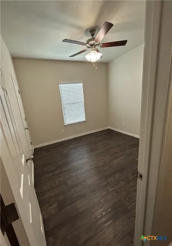 a view of a room with wooden floor and staircase