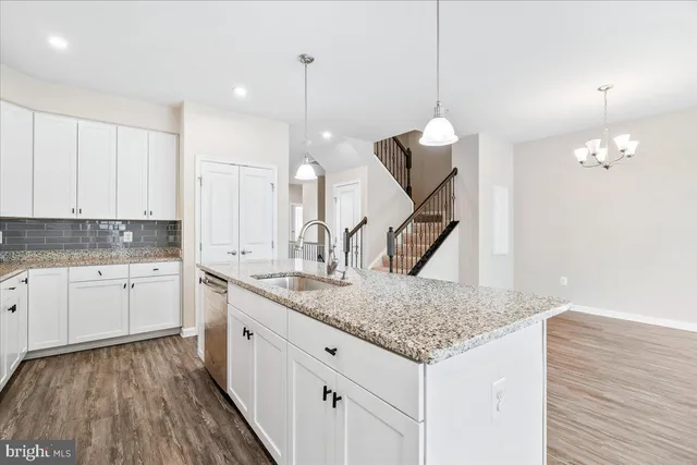 a kitchen with sink cabinets and wooden floor