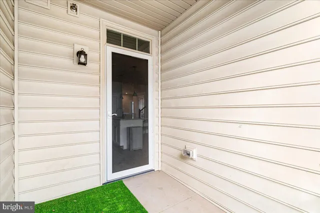 a view of a hallway with wooden floor and stairs