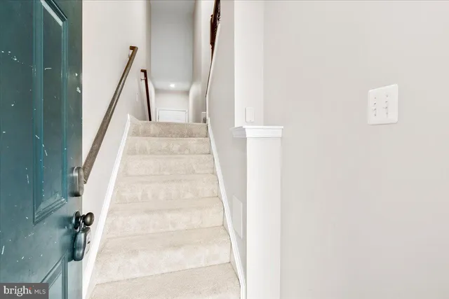 a view of staircase with white walls