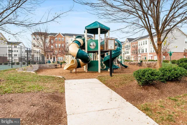a view of a house with a backyard and a slide