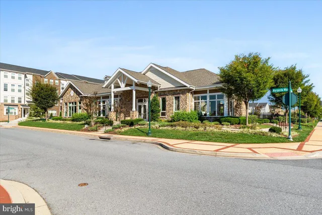 a view of yard with house and car parked in the background