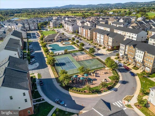 an aerial view of residential houses with outdoor space and swimming pool