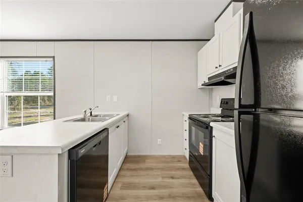 a kitchen with a sink and a refrigerator