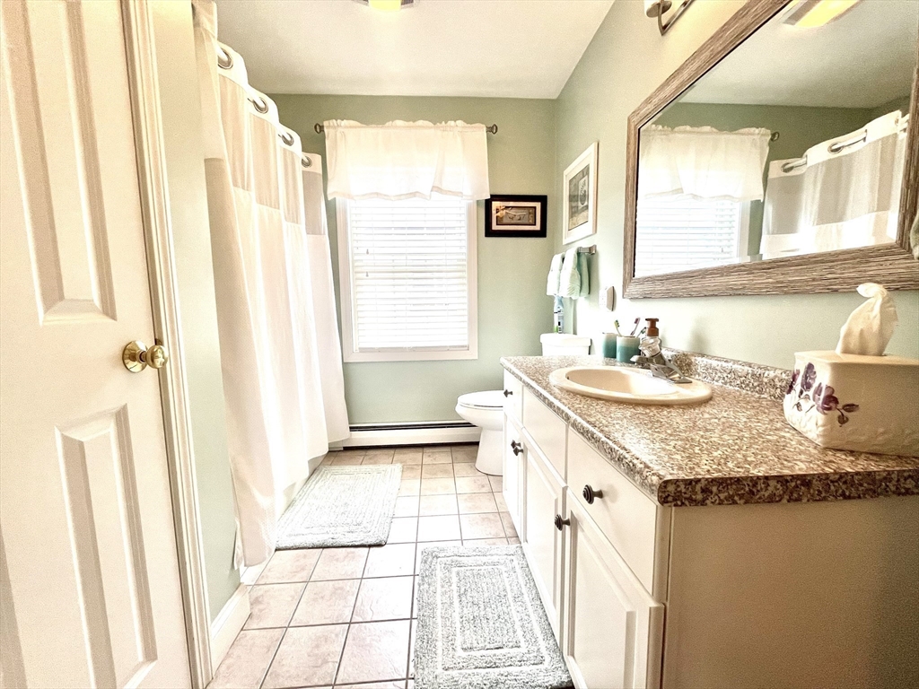 19 Lafayette Road, Unit 3 Ipswich, MA 01938 - Photo 18 of 41 a bathroom with a granite countertop sink and a mirror