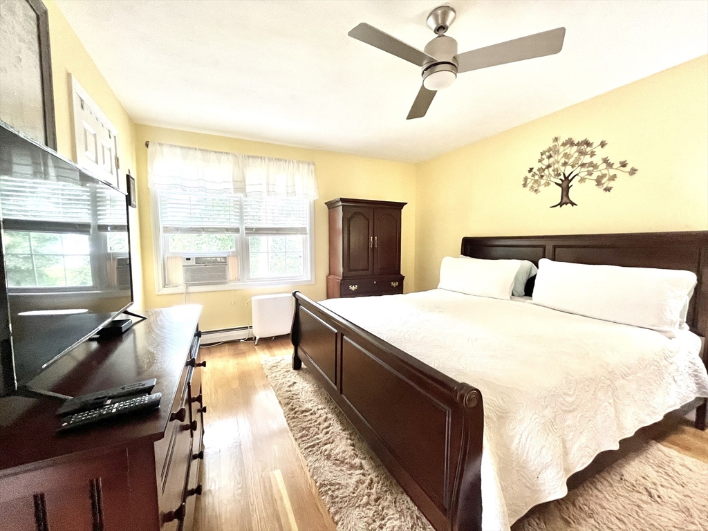 19 Lafayette Road, Unit 3 Ipswich, MA 01938 - Photo 20 of 41 a bedroom with a bed and wooden floor