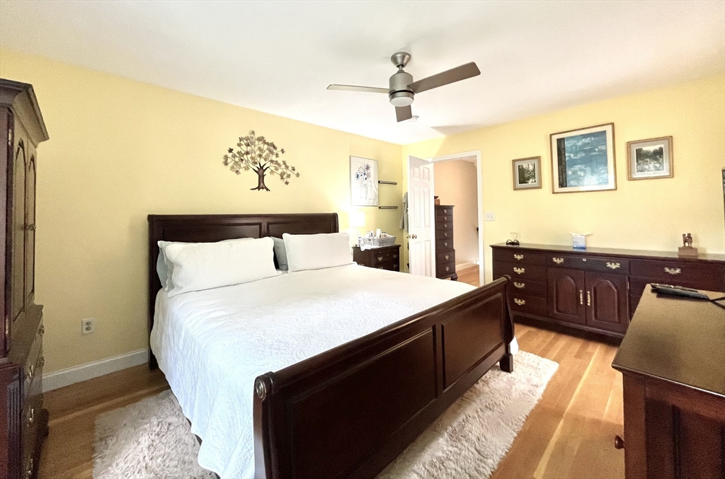 19 Lafayette Road, Unit 3 Ipswich, MA 01938 - Photo 21 of 41 a bedroom with a large bed and a chandelier