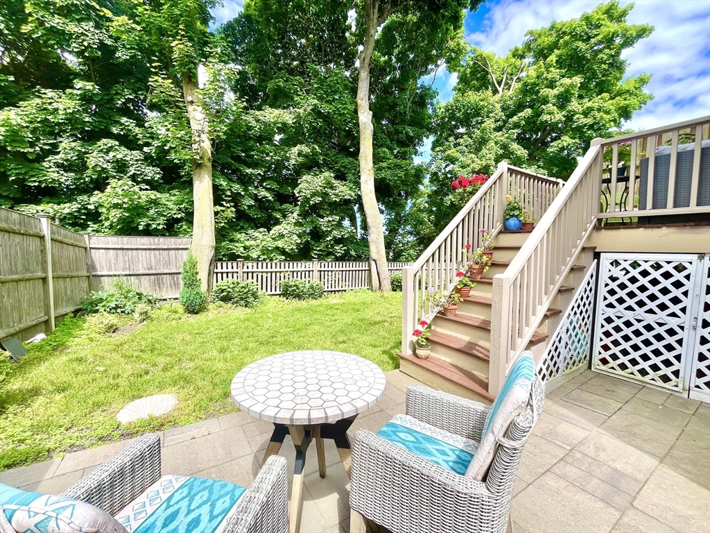 19 Lafayette Road, Unit 3 Ipswich, MA 01938 - Photo 38 of 41 a view of a deck with a table chairs and wooden fence
