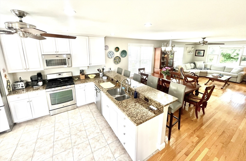 19 Lafayette Road, Unit 3 Ipswich, MA 01938 - Photo 6 of 41 a living room with stainless steel appliances furniture a rug and a kitchen view