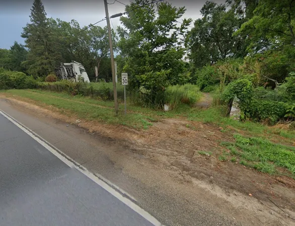 a front view of a house with a yard and a garage