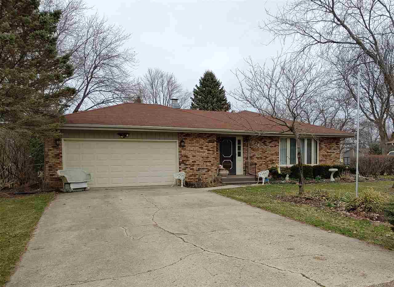 2874 Karr Road Belvidere, IL 61008 - Photo 1 of 20 a front view of a house with a yard and garage