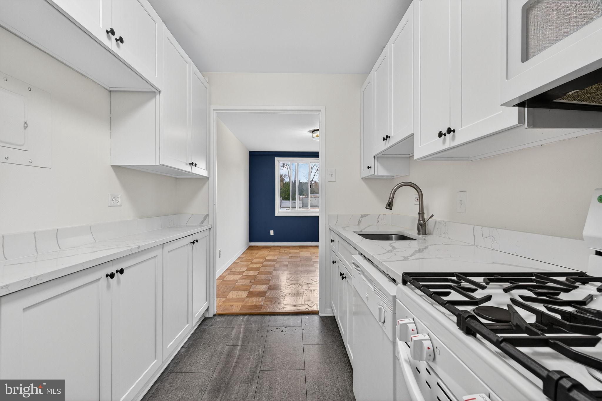 1900 Lyttonsville Road, Unit 618 Silver Spring, MD 20910 - Photo 16 of 36 a kitchen with a stove and a sink