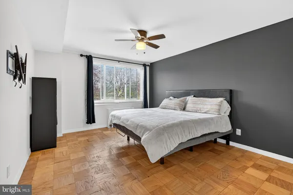a bedroom with a large bed and a large window