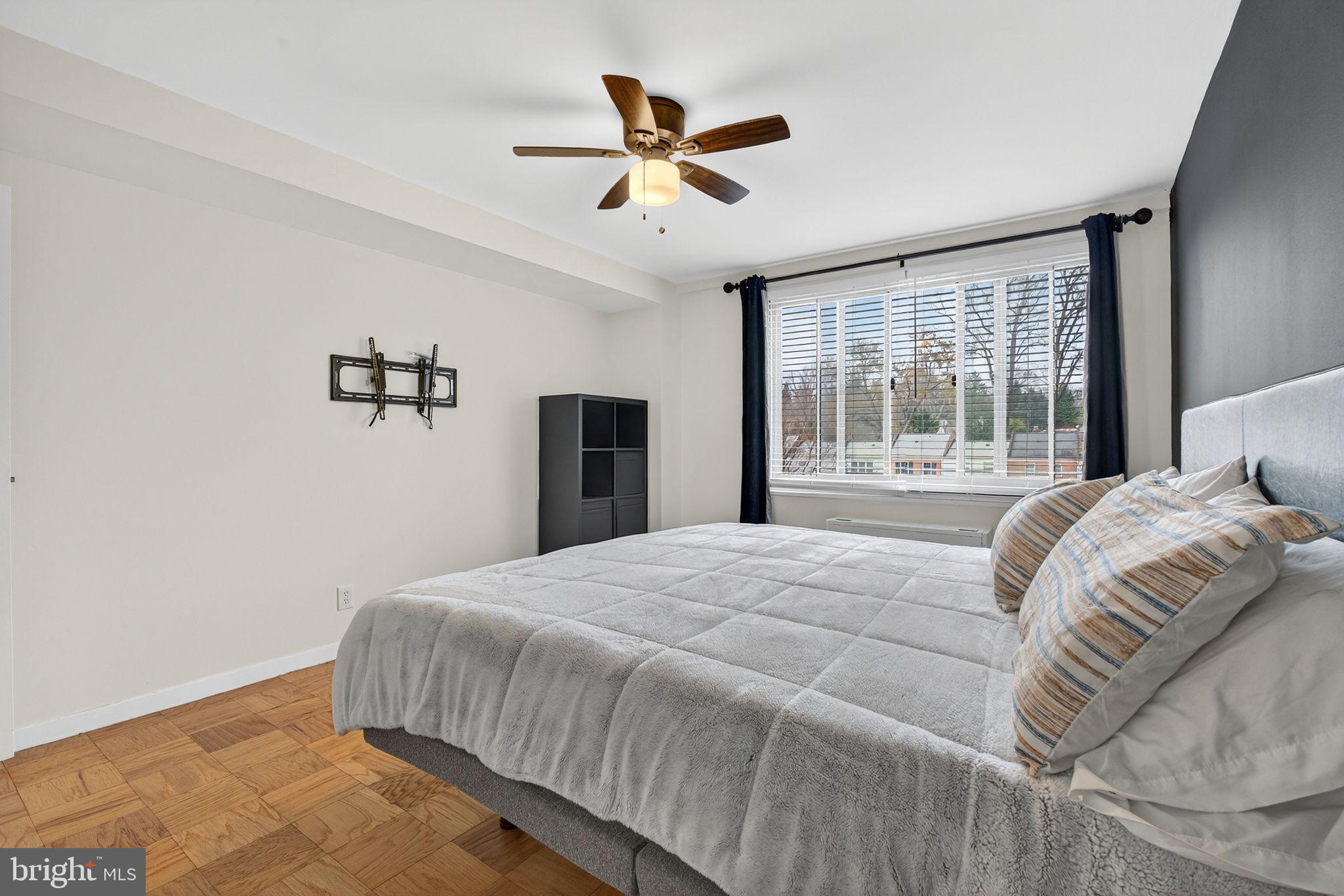 1900 Lyttonsville Road, Unit 618 Silver Spring, MD 20910 - Photo 22 of 36 a bedroom with a large bed and a large window