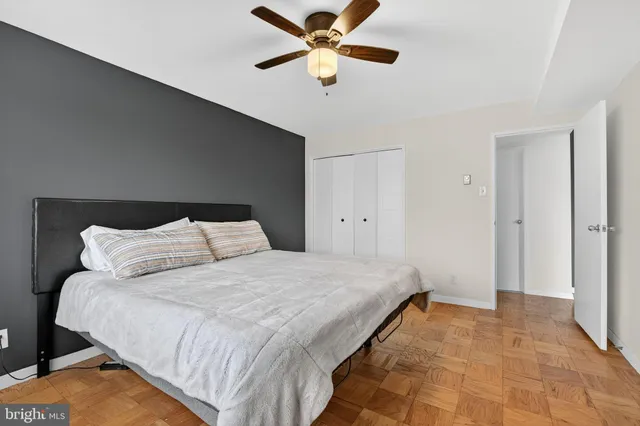 a bedroom with a large bed and a chandelier