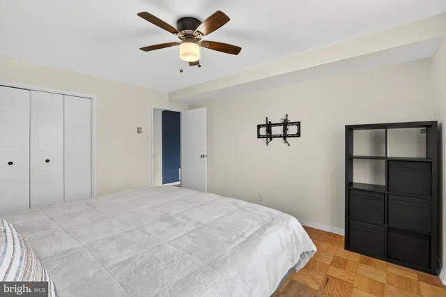 a bedroom with a large bed and a chandelier