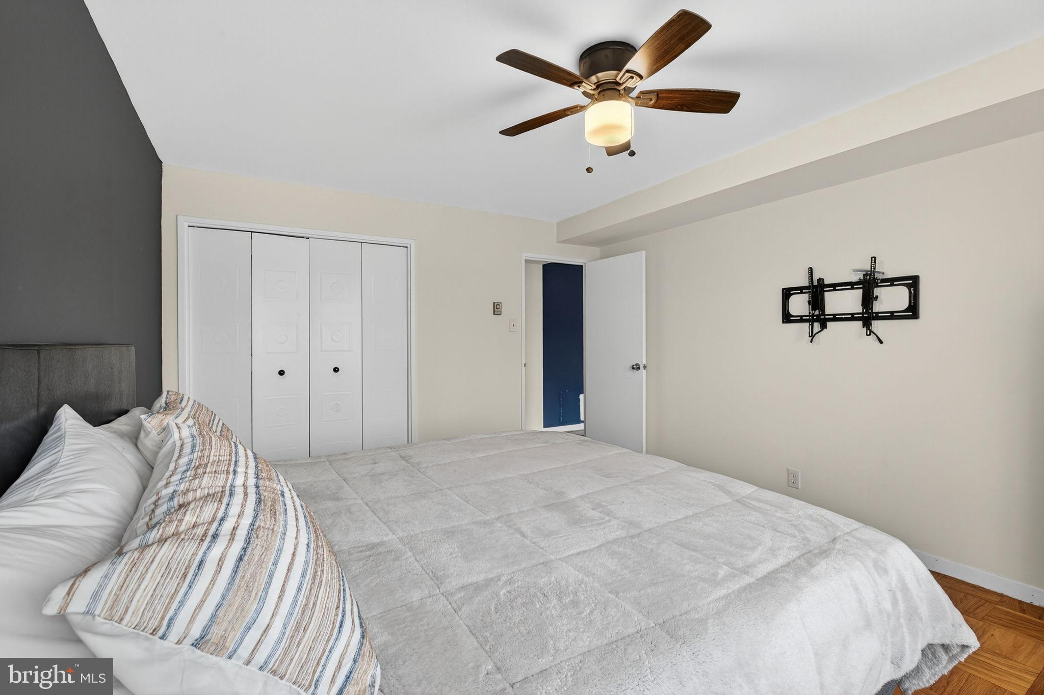 1900 Lyttonsville Road, Unit 618 Silver Spring, MD 20910 - Photo 25 of 36 a bedroom with a large bed and a chandelier