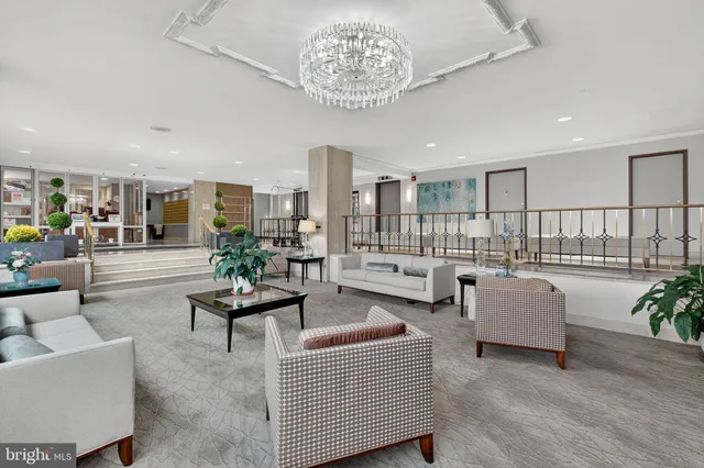 a living room with furniture and a chandelier