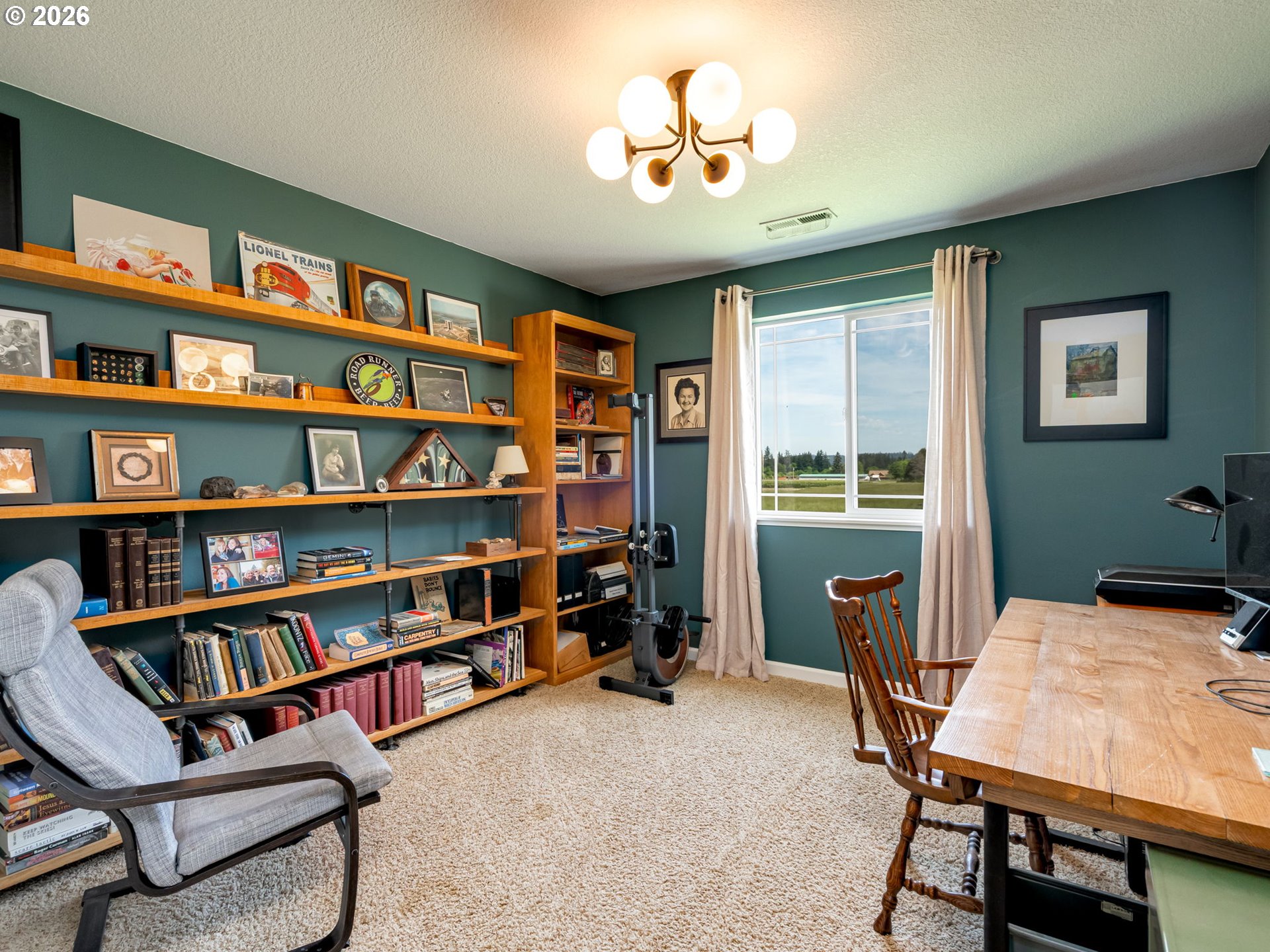 14200 South Union Mills Road Mulino, OR 97042 - Photo 21 of 46 a view of a workspace with furniture and a bookshelf