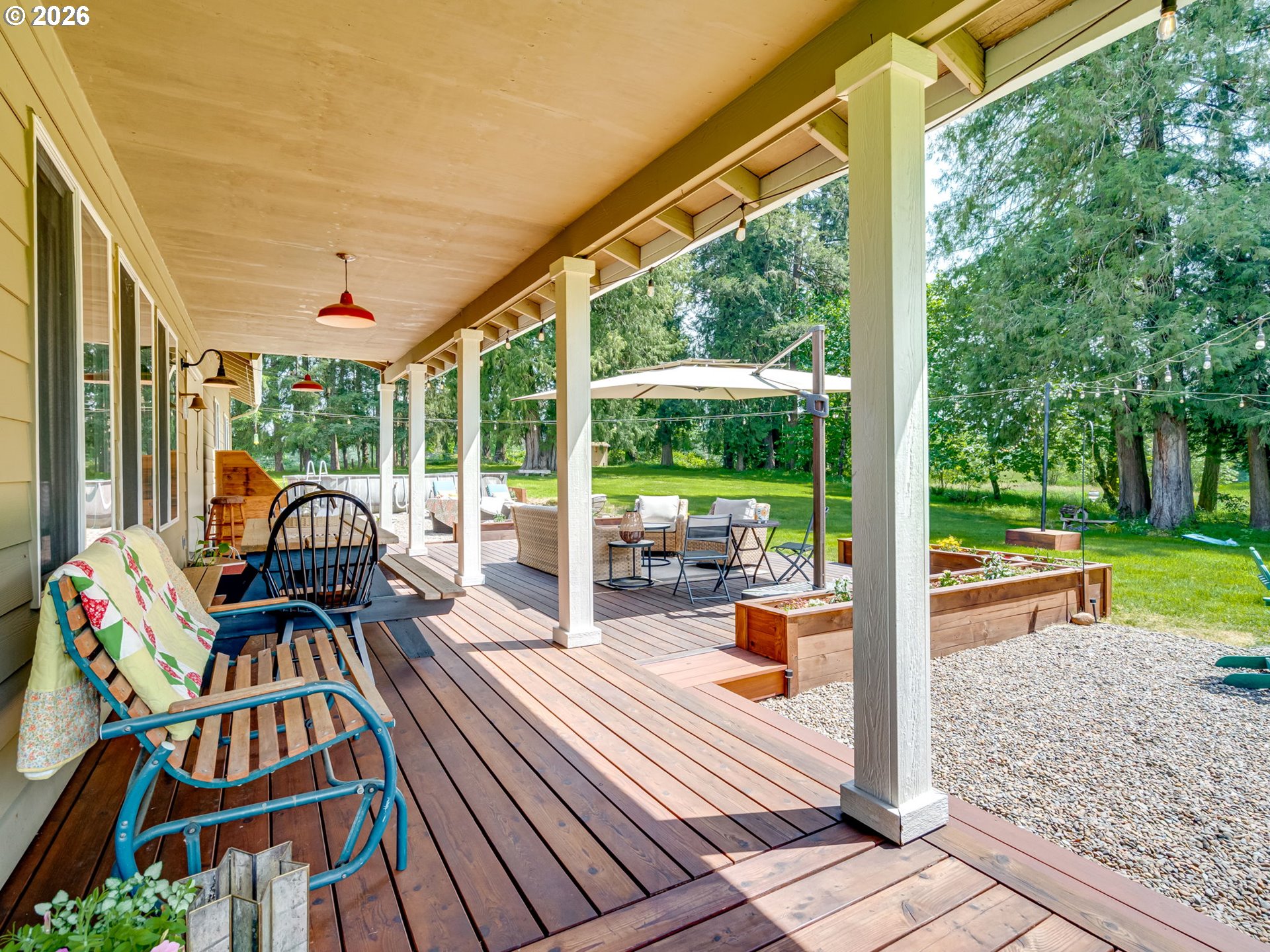 14200 South Union Mills Road Mulino, OR 97042 - Photo 30 of 46 a view of a patio with table and chairs and floor to ceiling window with garden