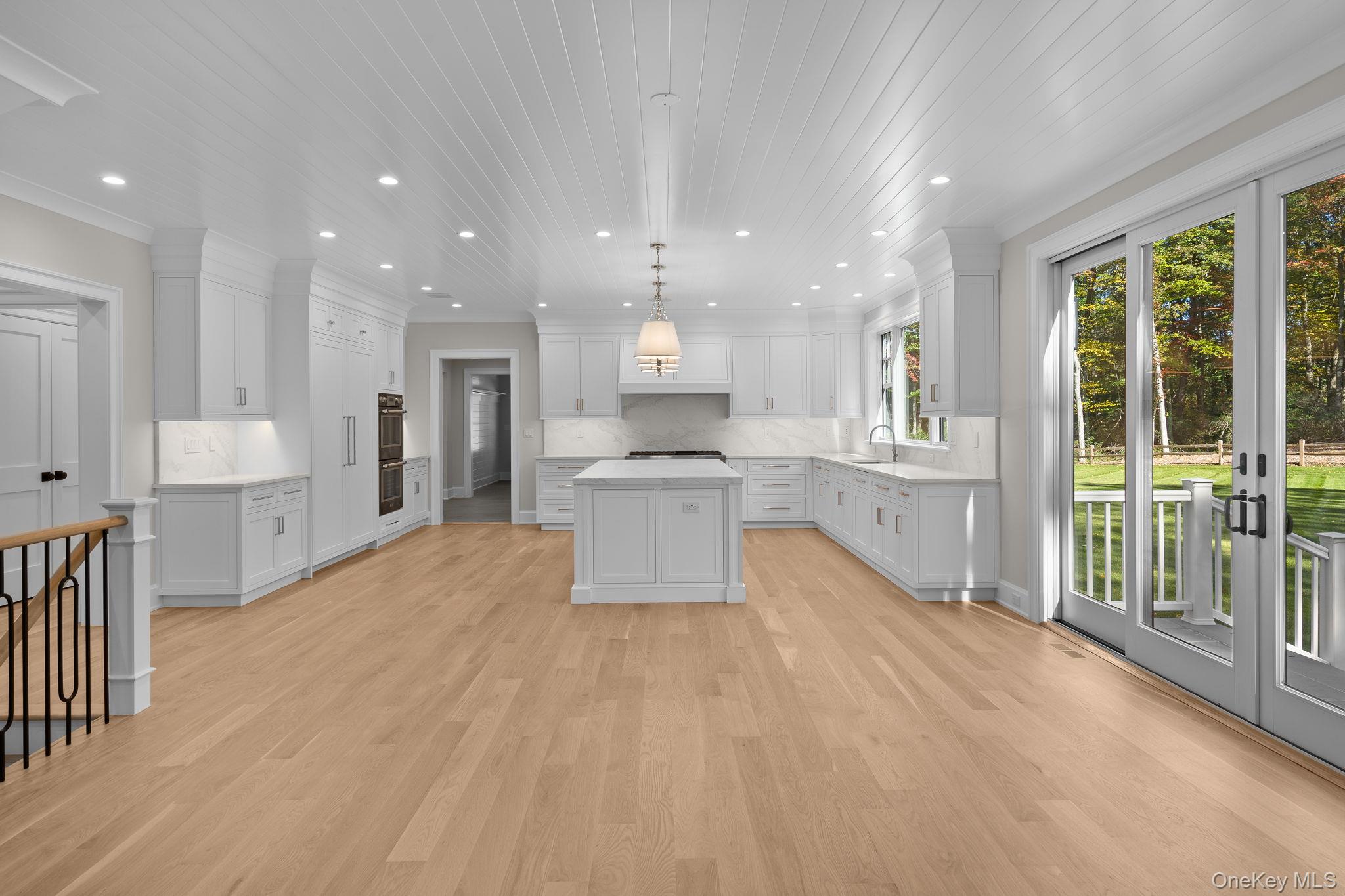 66 Saw Mill Road Cold Spring Harbor, NY 11724 - Photo 11 of 40 a large kitchen with stainless steel appliances kitchen island granite countertop a large cabinets a sink and a counter top space