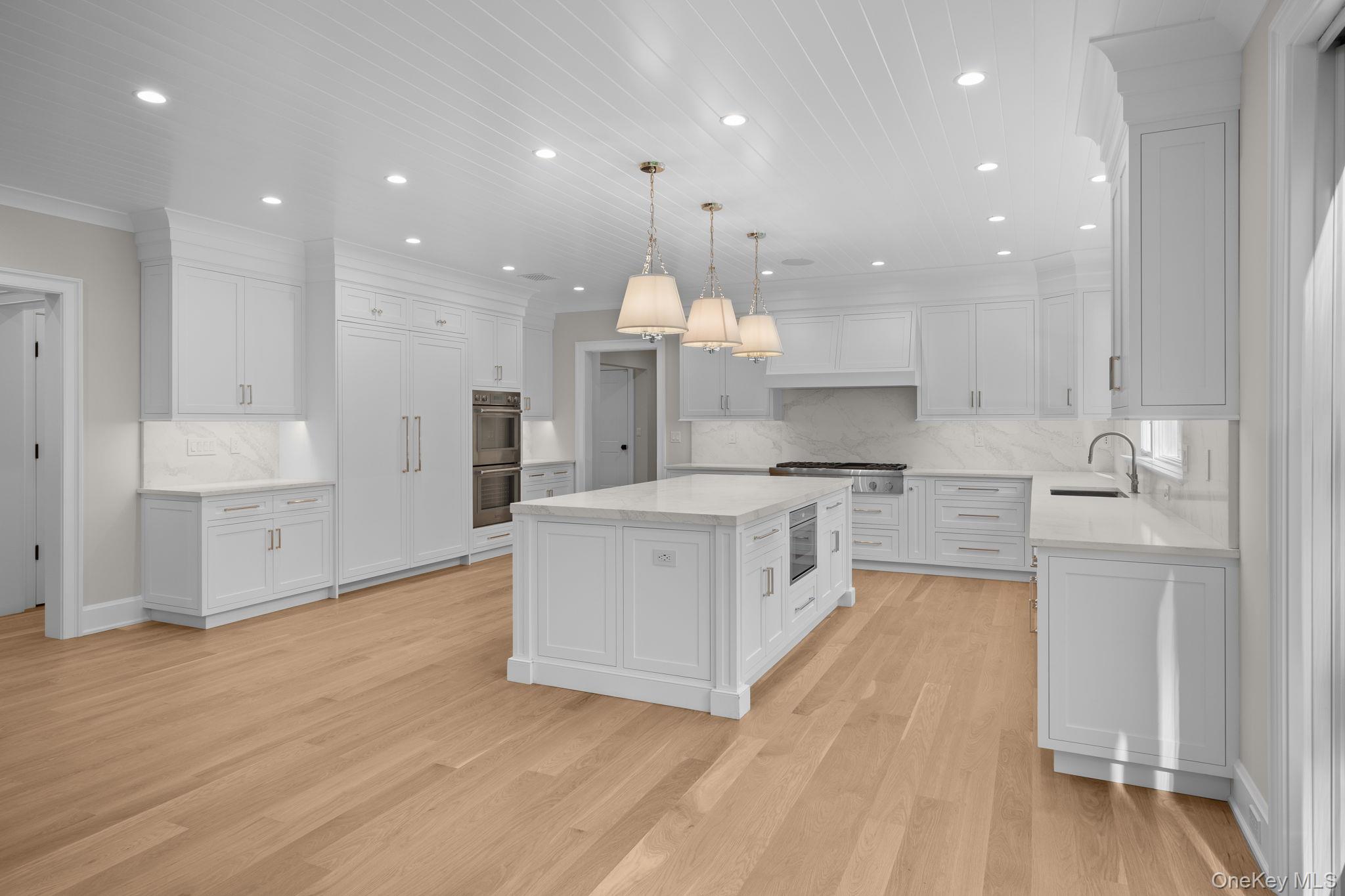 66 Saw Mill Road Cold Spring Harbor, NY 11724 - Photo 12 of 40 a large kitchen with stainless steel appliances kitchen island granite countertop a large counter top and a stove top oven