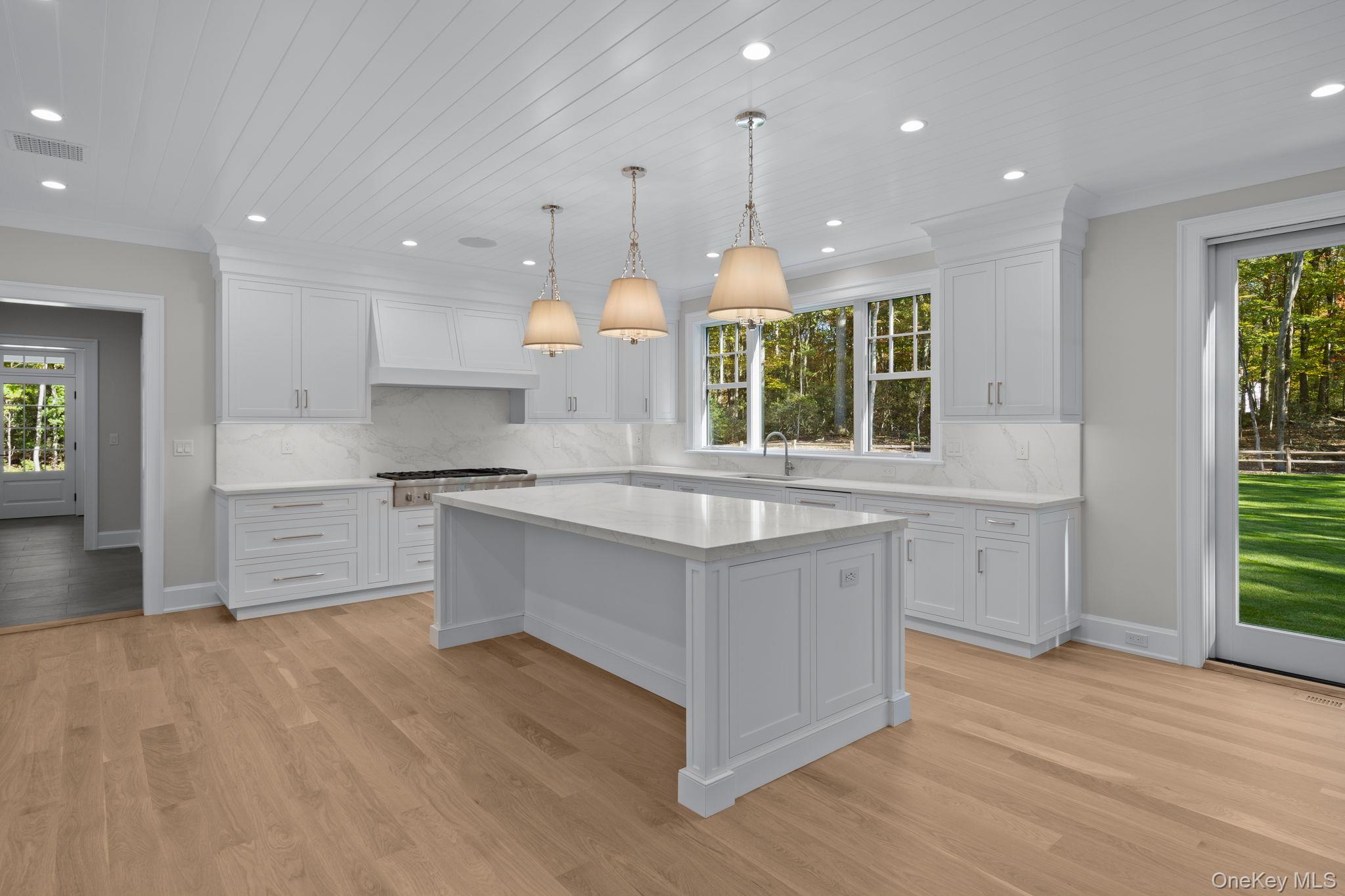 66 Saw Mill Road Cold Spring Harbor, NY 11724 - Photo 13 of 40 a kitchen with stainless steel appliances granite countertop a large stove a sink dishwasher and a large refrigerator with wooden floor