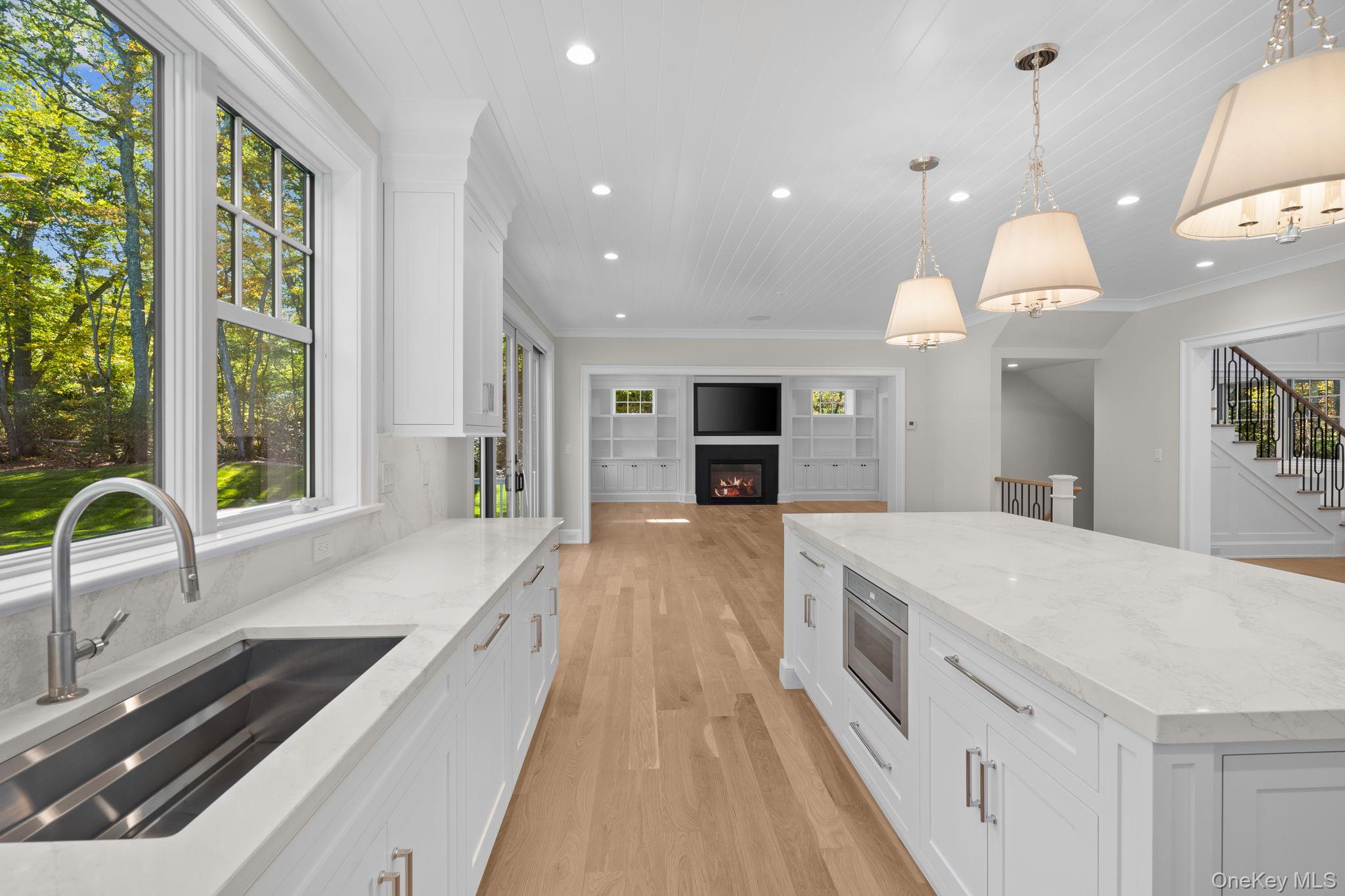 66 Saw Mill Road Cold Spring Harbor, NY 11724 - Photo 15 of 40 a large kitchen with kitchen island a large counter space a sink a window and stainless steel appliances