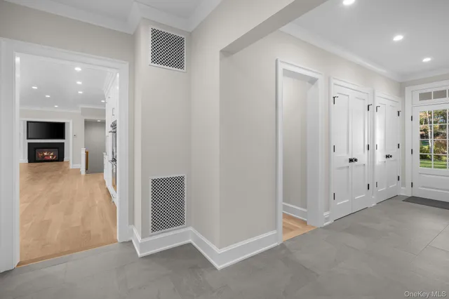 an empty room with closet and a fireplace