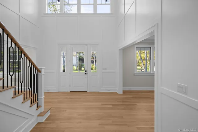 a view of an entryway with wooden floor