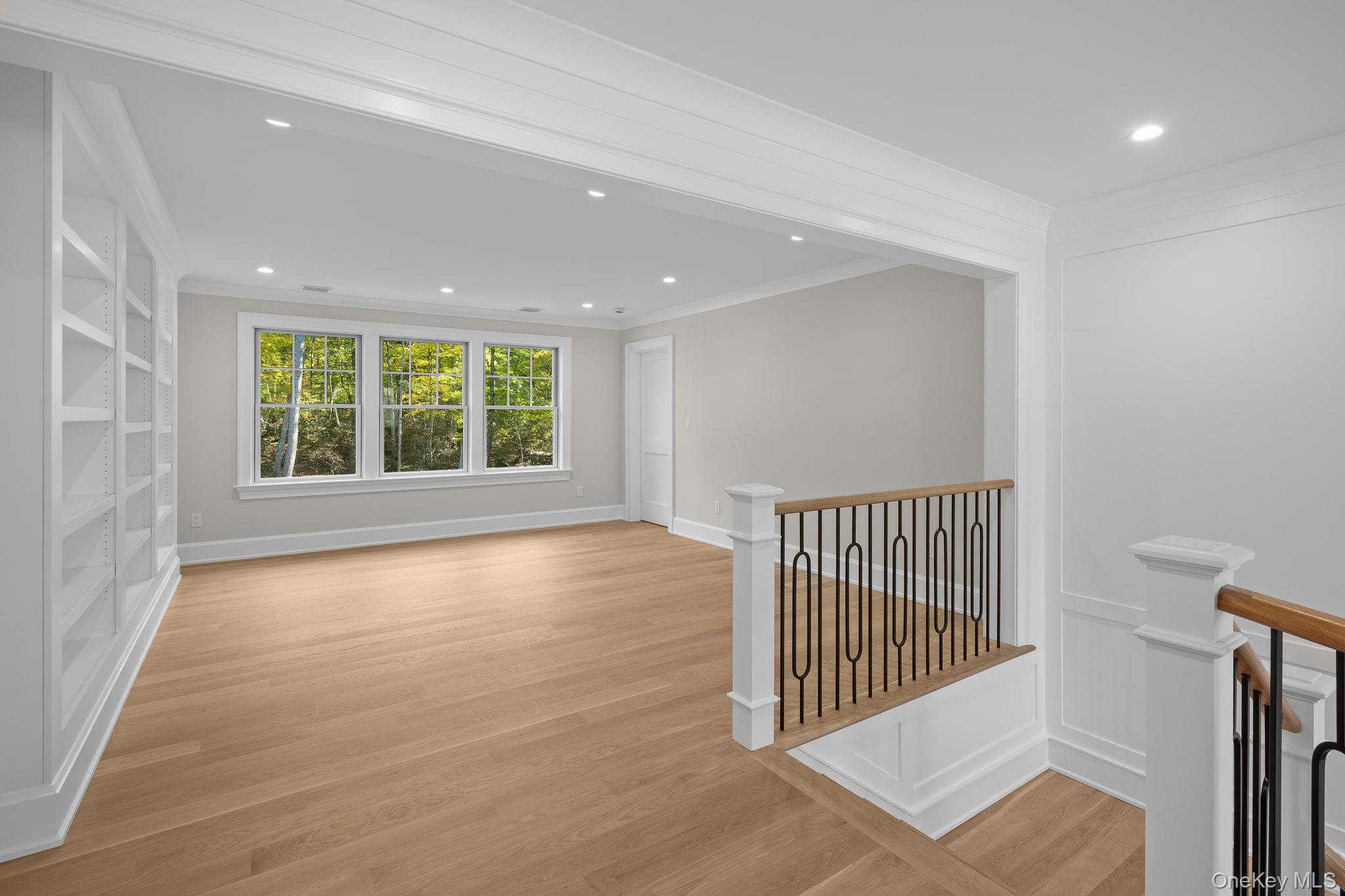 66 Saw Mill Road Cold Spring Harbor, NY 11724 - Photo 23 of 40 an empty room with wooden floor and windows