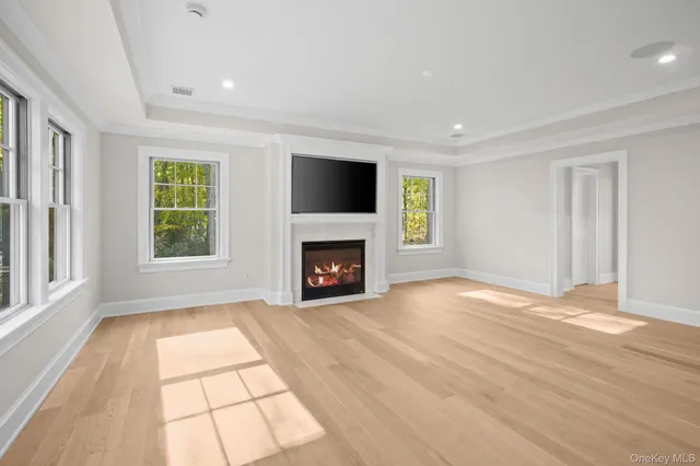 a view of an empty room with window and fire place