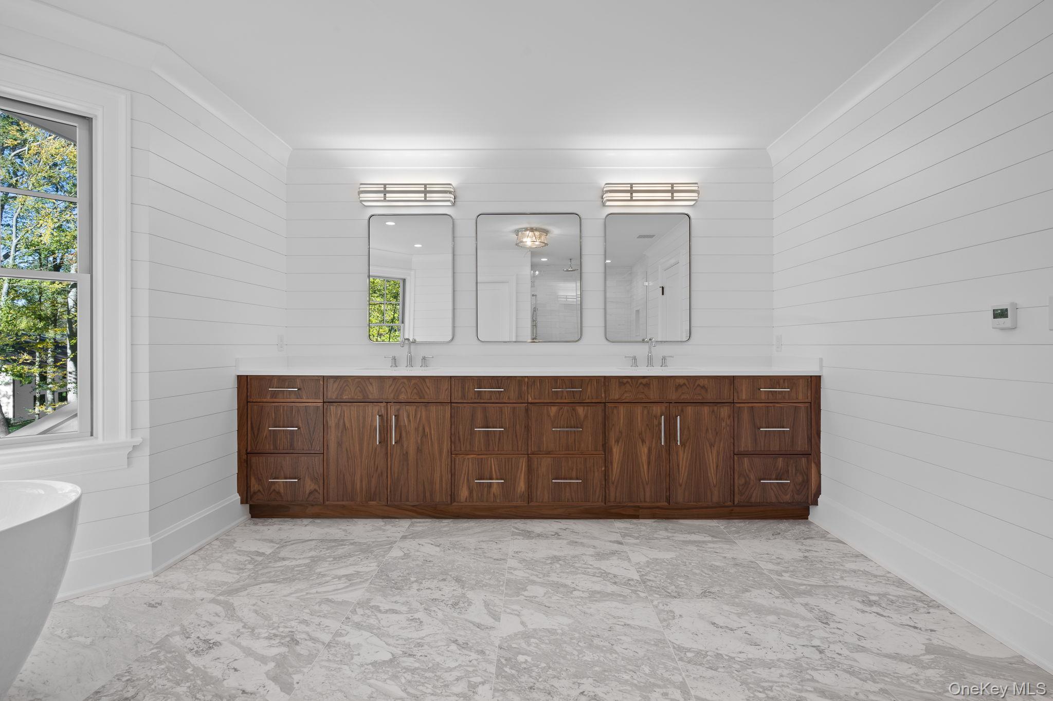 66 Saw Mill Road Cold Spring Harbor, NY 11724 - Photo 27 of 40 a bathroom with a granite countertop sink and a mirror
