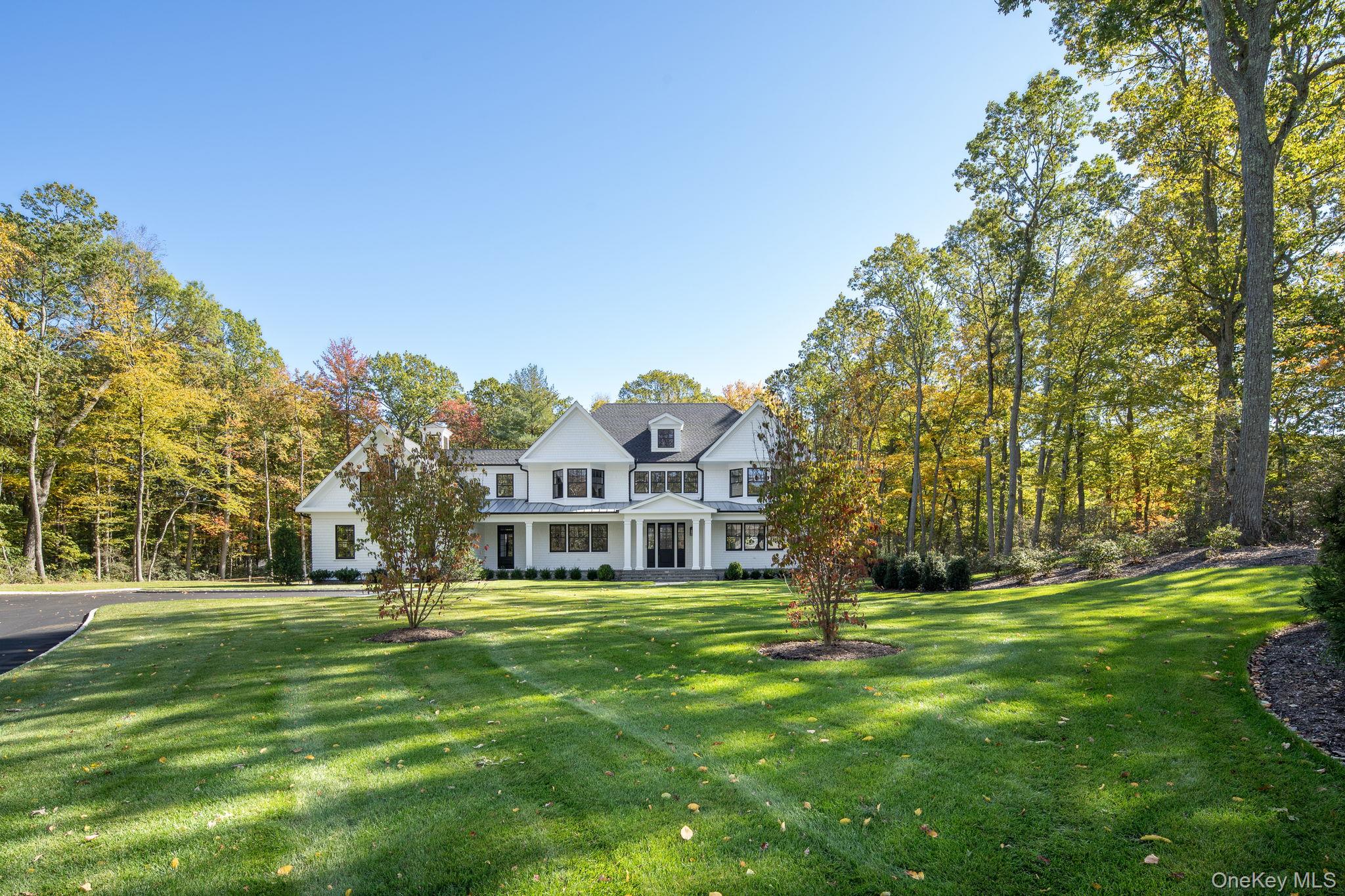 66 Saw Mill Road Cold Spring Harbor, NY 11724 - Photo 4 of 40 a front view of a house with a yard