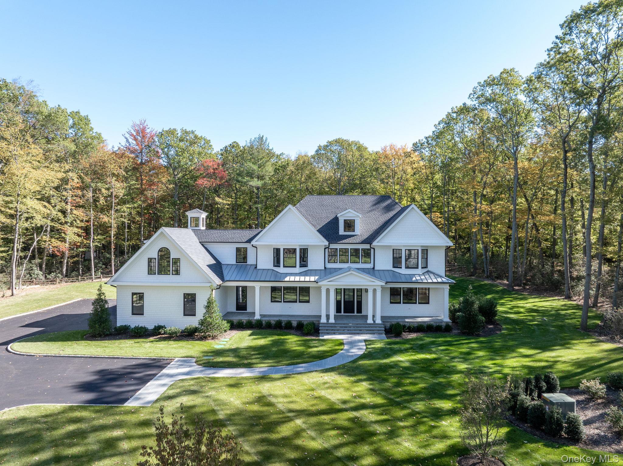 66 Saw Mill Road Cold Spring Harbor, NY 11724 - Photo 5 of 40 a front view of a house with a yard table and chairs