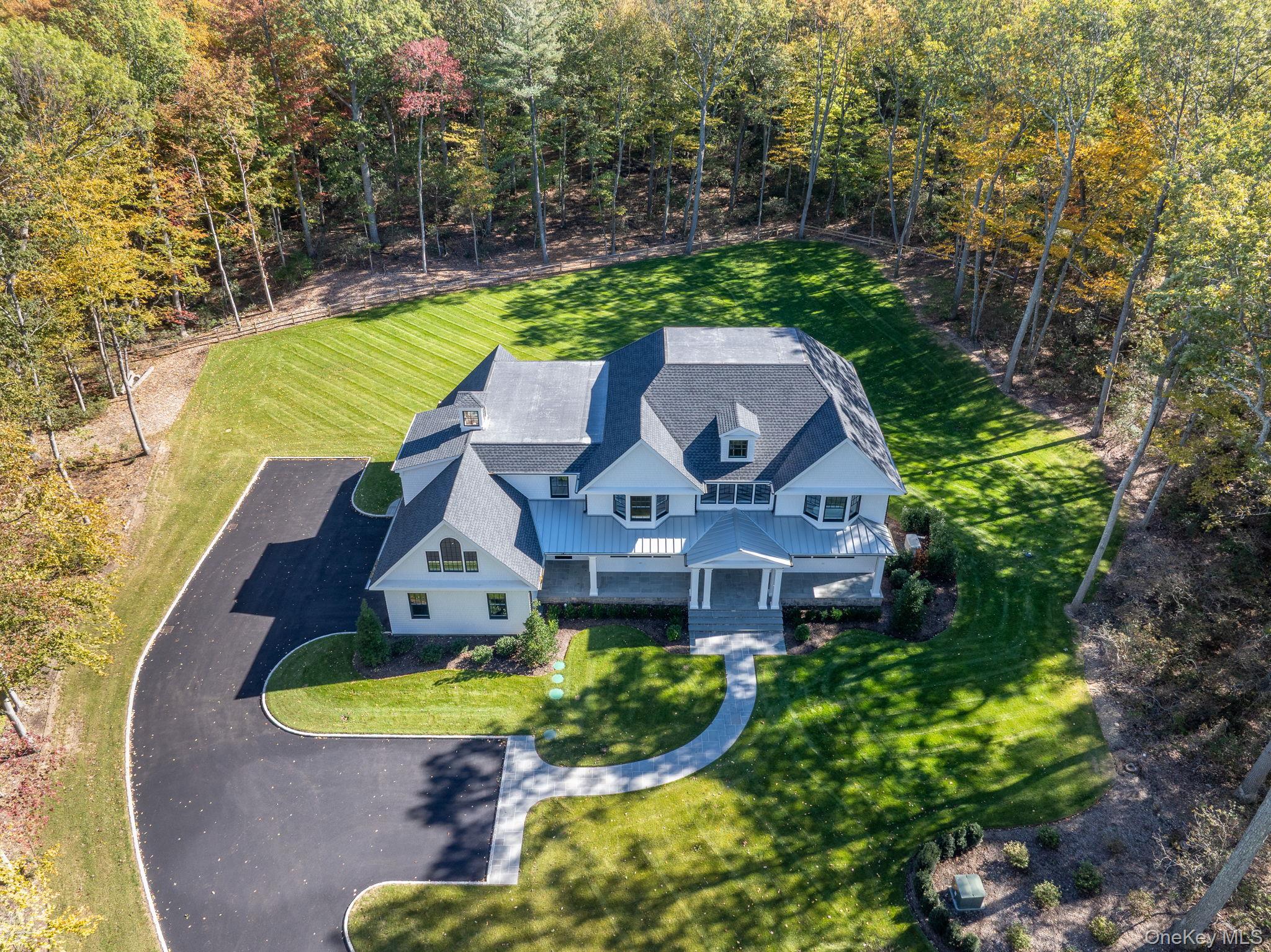 66 Saw Mill Road Cold Spring Harbor, NY 11724 - Photo 6 of 40 an aerial view of a house with a swimming pool