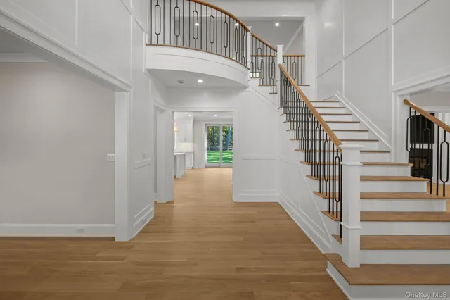 a view of entryway and hall with wooden floor