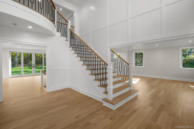 a view of entryway and hall with wooden floor