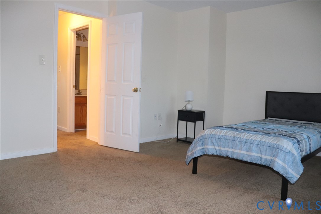 4073 Trisha Trail Midlothian, VA 23112 - Photo 11 of 22 a bedroom with a bed and a table in it