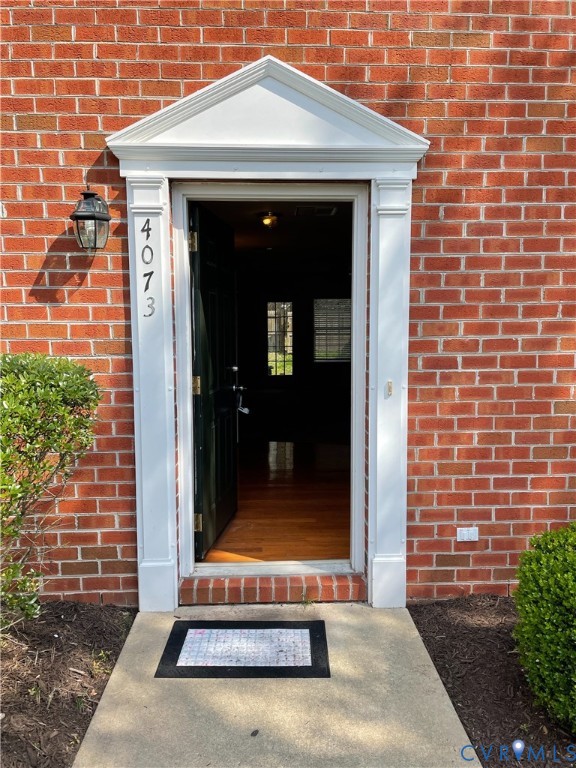 4073 Trisha Trail Midlothian, VA 23112 - Photo 2 of 22 a view of a brick house with a small yard