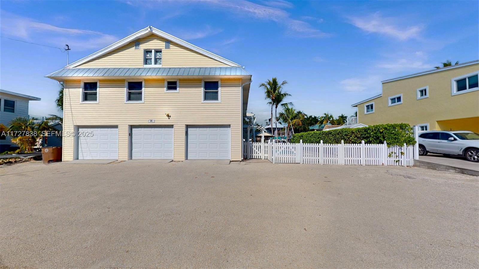 28 Center Lane Key Largo, FL 33037 - Photo 82 of 93 a view of a house with a yard and garage