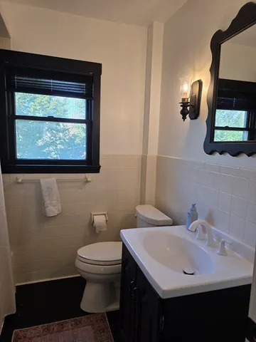 a bedroom with a bed next to a window