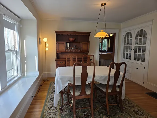 a dining room with furniture window wooden floor