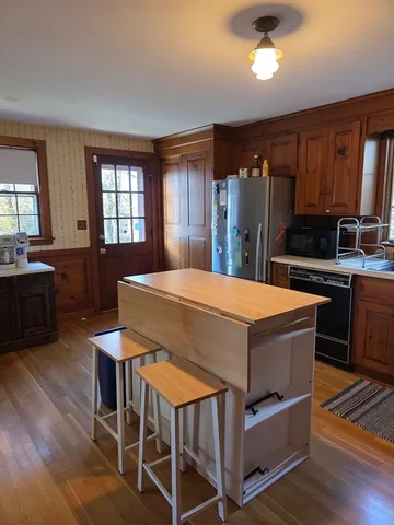 a stove top oven sitting inside of a kitchen