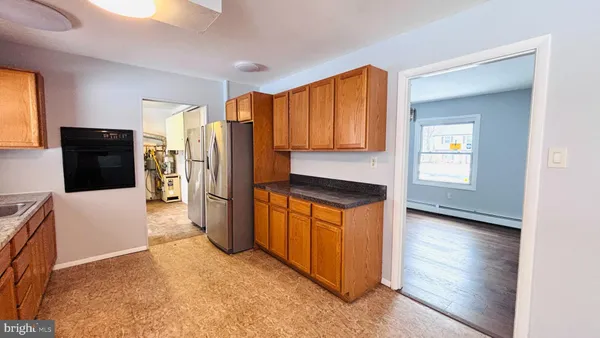 a kitchen with stainless steel appliances granite countertop a refrigerator and a stove top oven