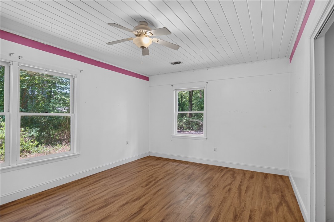 123 Robin Road Westminster, SC 29693 - Photo 40 of 50 A quiet bedroom featuring rich hardwood flooring and a functional ceiling fan.