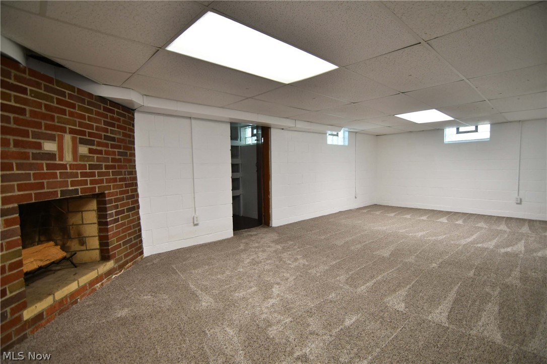 197 North Medina Line Road Akron, OH 44333 - Photo 27 of 35 FINISHED REC ROOM WITH FIREPLACE AND NEW CARPET