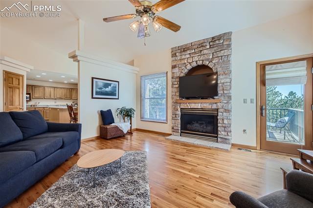 3715 Range View Road Monument, CO 80132 - Photo 7 of 49 Living room featuring high vaulted ceiling, ceiling fan, door to the outdoor patio and light wood-type flooring.