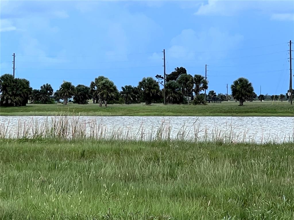 7 Willow Road Placida, FL 33946 - Photo 8 of 11 a view of a green field with wooden fence
