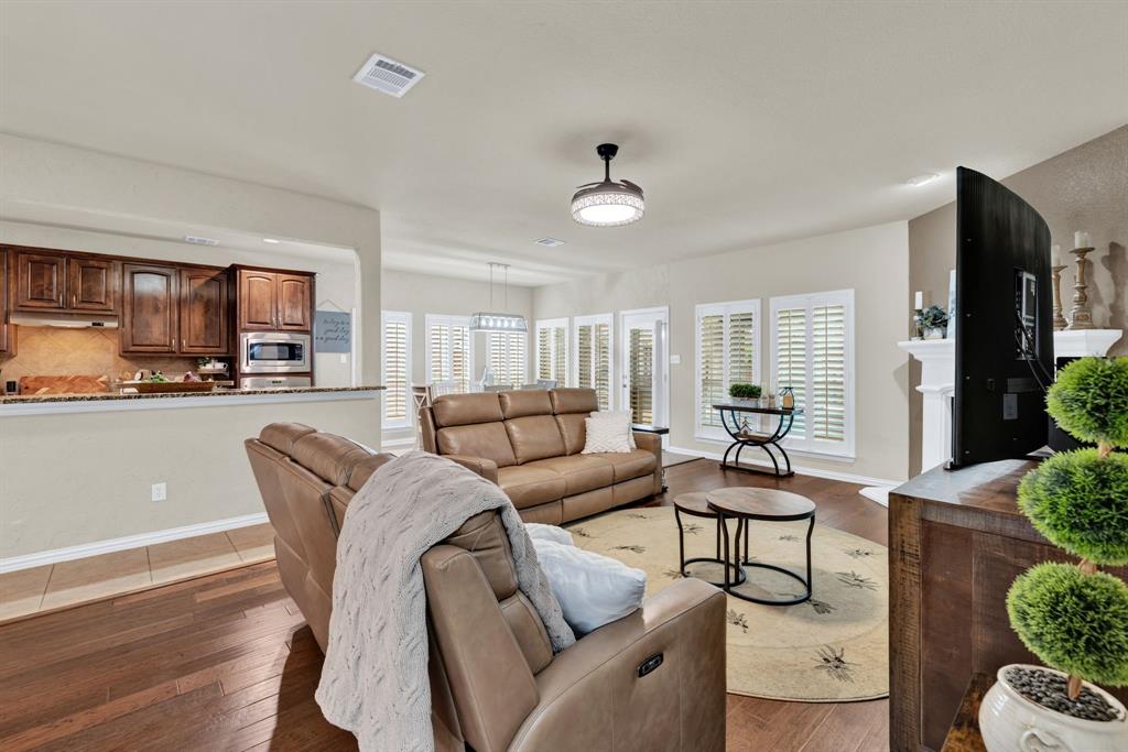 1701 Meadow Ranch Road McKinney, TX 75071 - Photo 11 of 40 a living room with furniture and a kitchen view